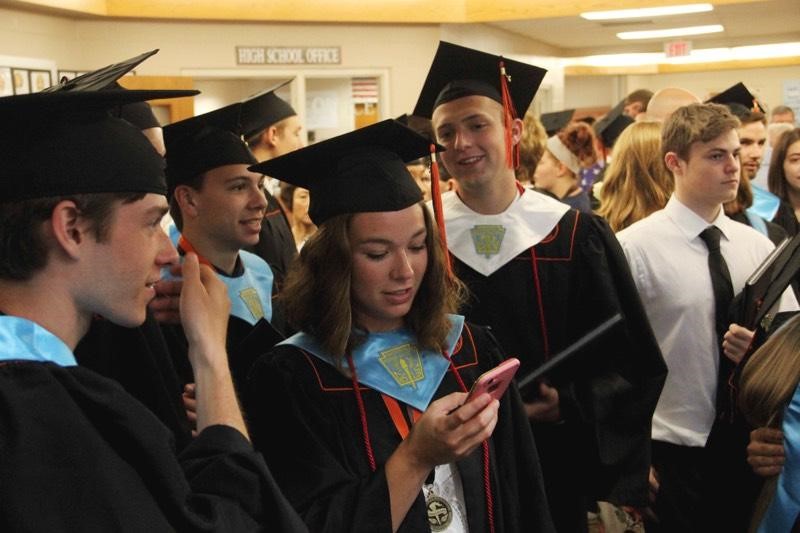 students looking at diplomas